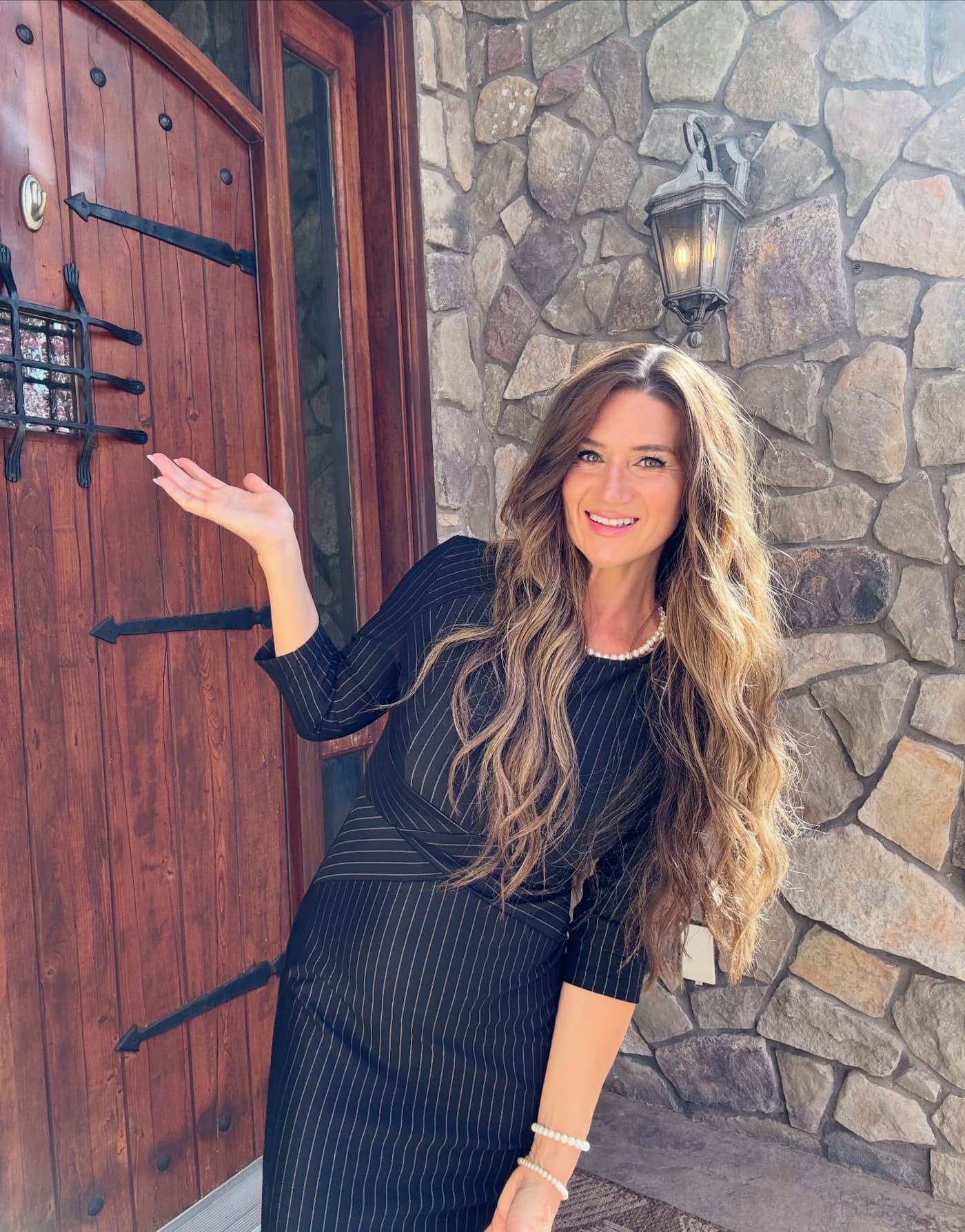 Sarah Heiner welcoming visitors at the front door of a home